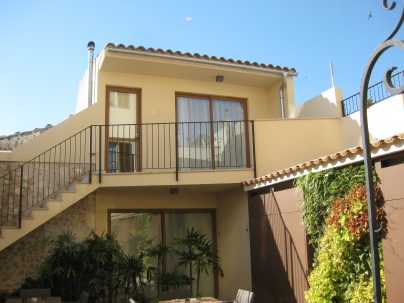 The rear of two of the hotel rooms, showing the balcony
